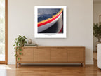 Red Stripe Dinghy Bow coastal canvas print on the wall of a living room above a sideboard