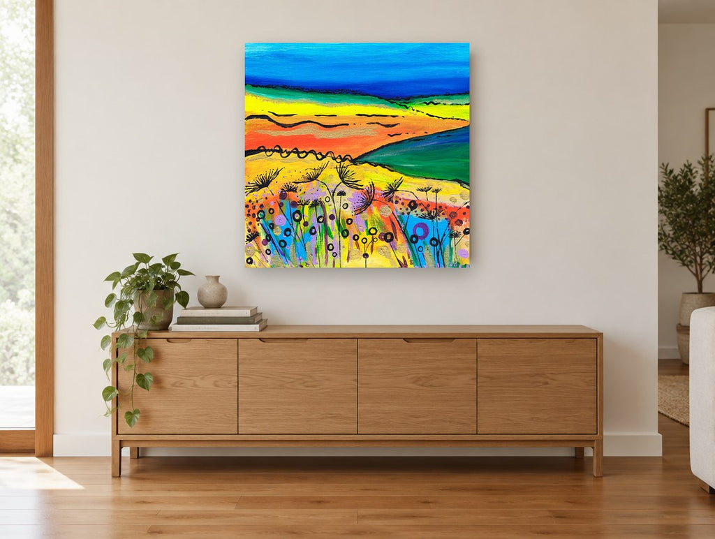 Bright Meadow Hills landscape canvas print on the wall of a living room above a sideboard