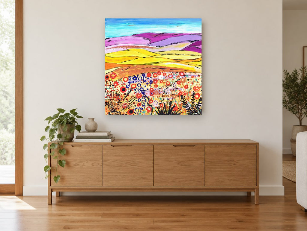Lilac Hills Poppy Meadow landscape canvas print on the wall of a living room above a sideboard