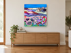 Cottage Above Poppy Meadow landscape canvas print on the wall of a living room above a sideboard
