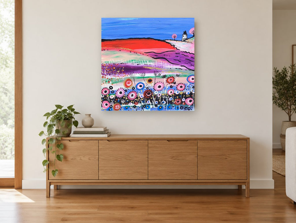 Poppy Hill Cottage landscape canvas print on the wall of a living room above a sideboard
