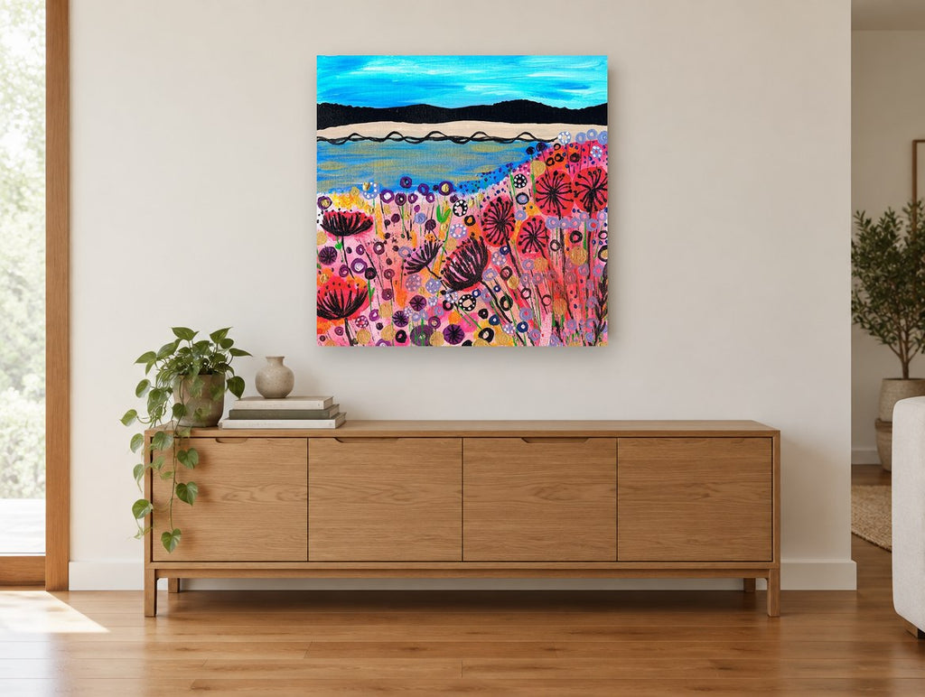 Poppy Shore Meadow coastal canvas print on the wall of a living room above a sideboard