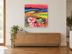 Crimson Sky Meadow landscape canvas print on the wall of a living room above a sideboard