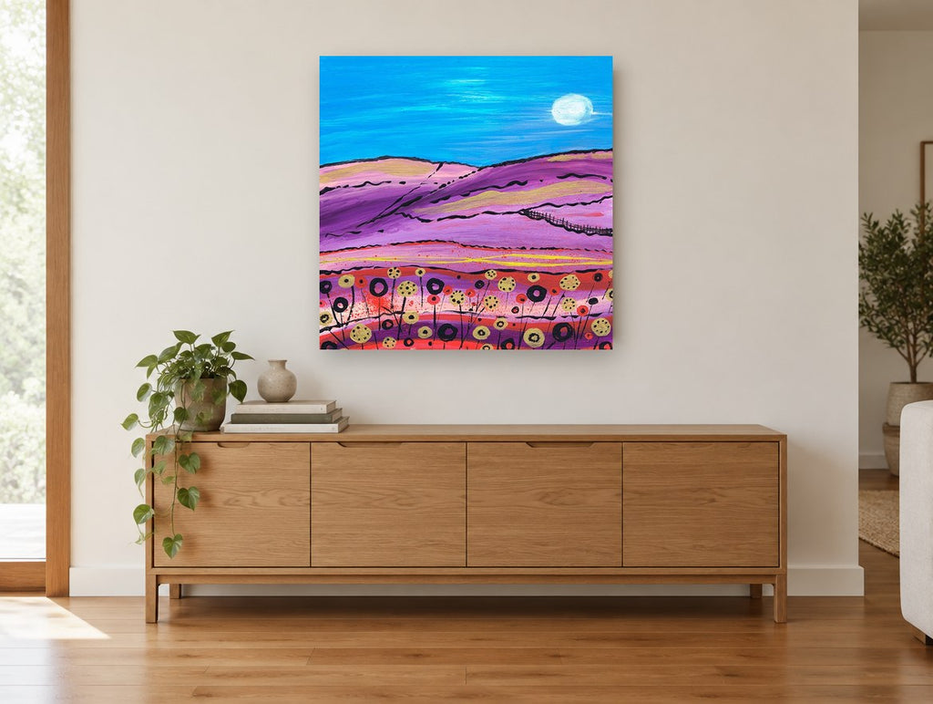 Moonlit Purple Hills landscape canvas print on the wall of a living room above a sideboard