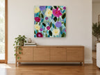 Garden of Soft Blooms floral canvas print on the wall of a living room above a sideboard
