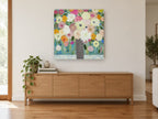 Scalloped Vase Bouquet floral canvas print on the wall of a living room above a sideboard