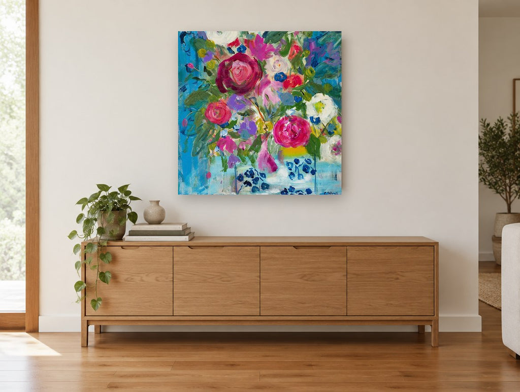 Blue Vase Bouquet floral canvas print on the wall of a living room above a sideboard
