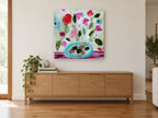 Pink Blooms in Turquoise Bowl floral canvas print on the wall of a living room above a sideboard