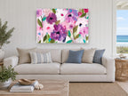 Orchid Haze Bloom floral canvas print on the wall of a beach house living room