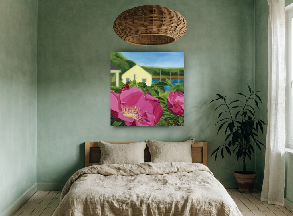 Beach Rose Cottage coastal canvas print on the wall of a bedroom