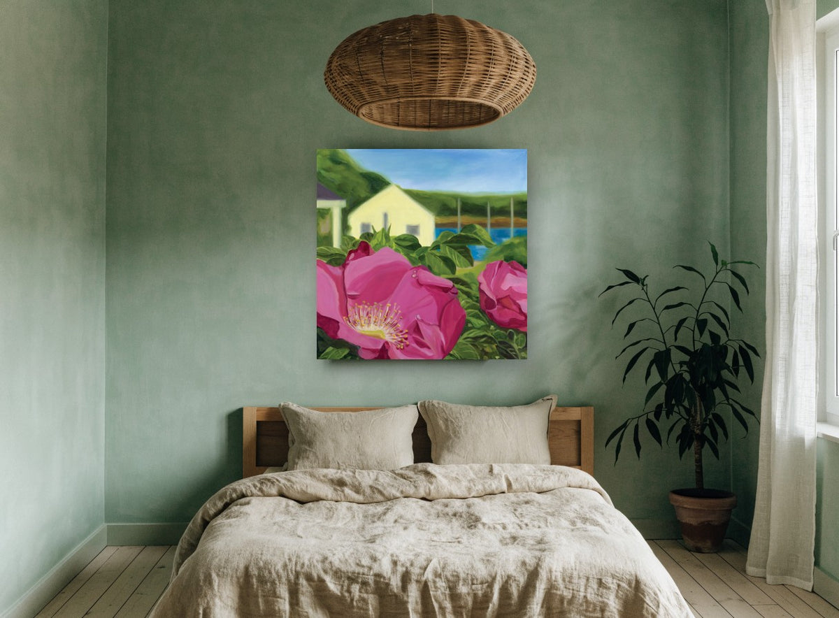 Beach Rose Cottage coastal canvas print on the wall of a bedroom