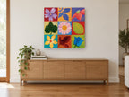 Nine Square Garden floral canvas print on the wall of a living room above a sideboard