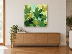 Maple Canopy Greens floral canvas print on the wall of a living room above a sideboard