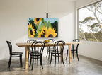 Sunflowers Against Blue floral canvas print on the wall of a dining room