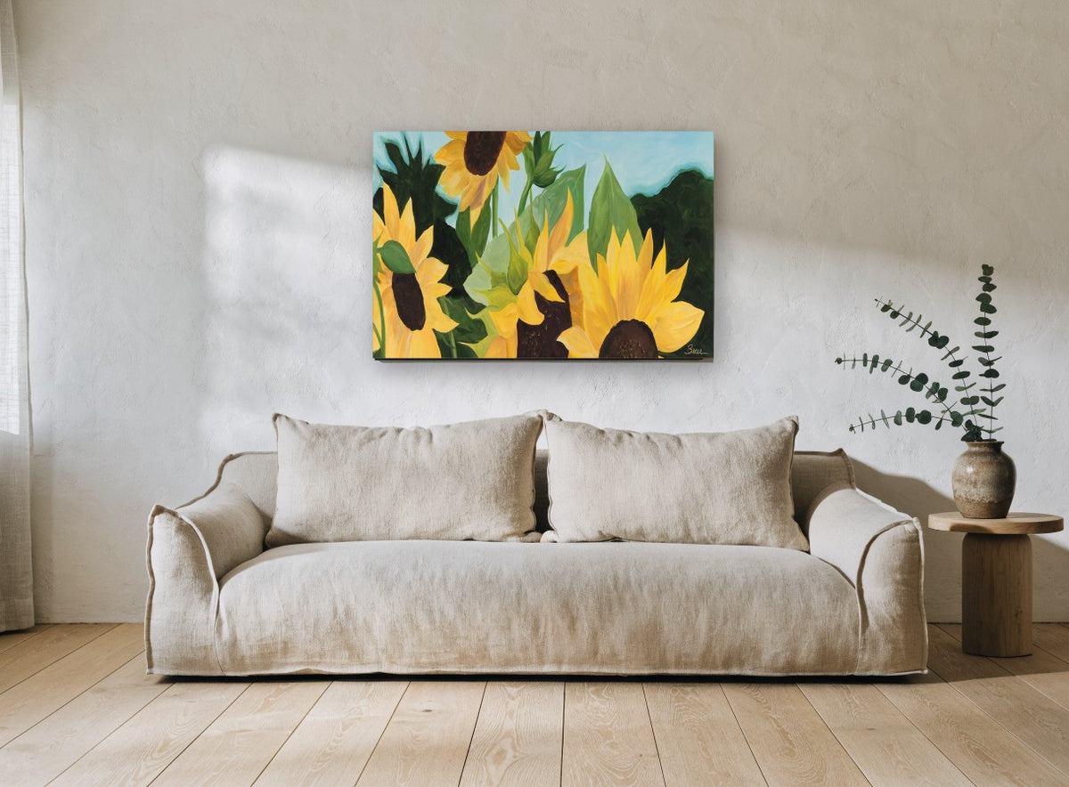 Sunflowers Against Blue floral canvas print on the wall of a living room