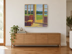 Morning Sunroom View coastal canvas print on the wall of a living room above a sideboard