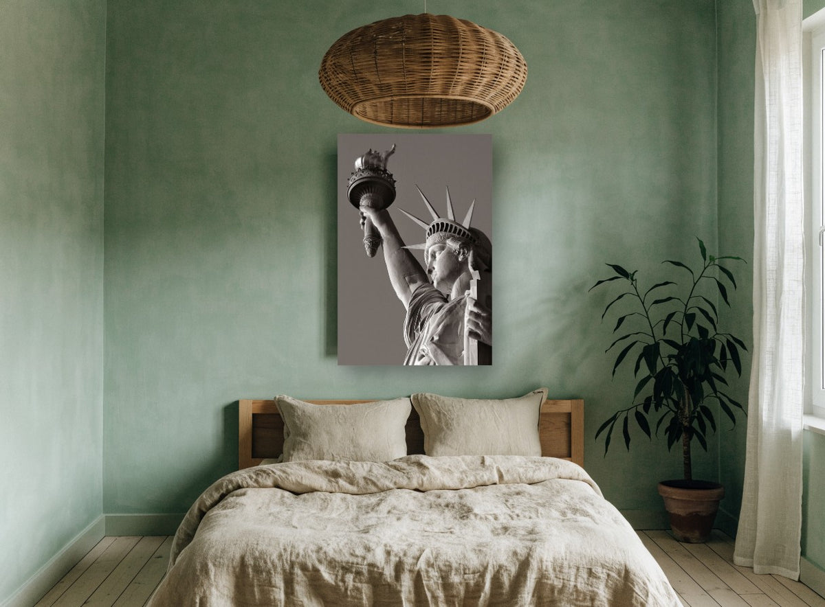 Liberty Raised Torch city canvas print on the wall of a bedroom