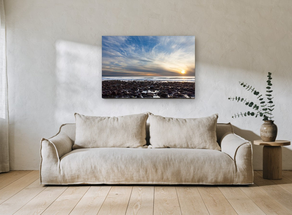 Low Tide Sunset Rocks coastal canvas print on the wall of a living room