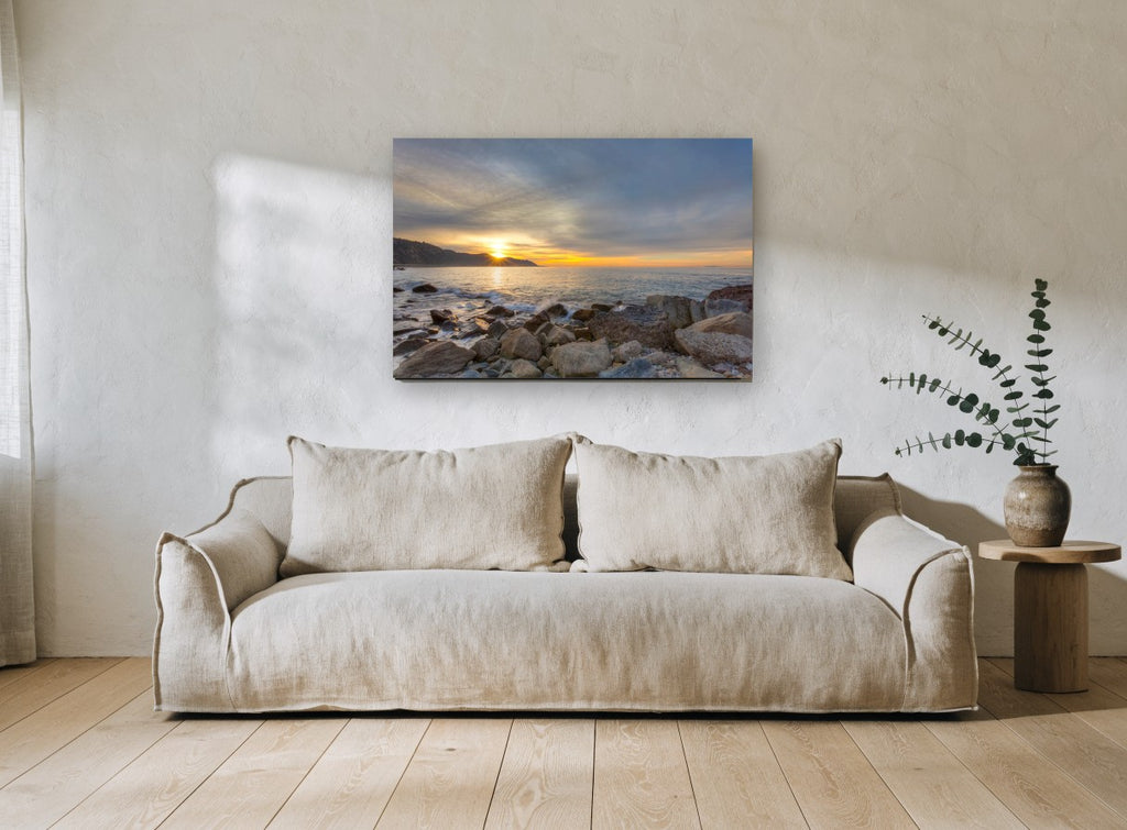 Sunrise Over Rocky Shore coastal canvas print on the wall of a living room