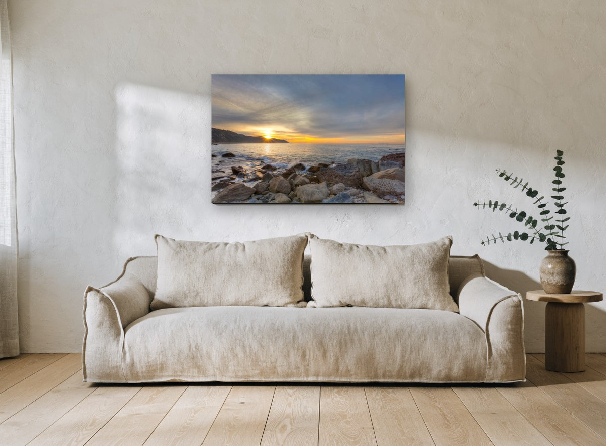 Sunrise Over Rocky Shore coastal canvas print on the wall of a living room