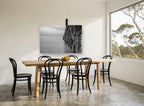 Quiet Pier Pilings coastal canvas print on the wall of a dining room