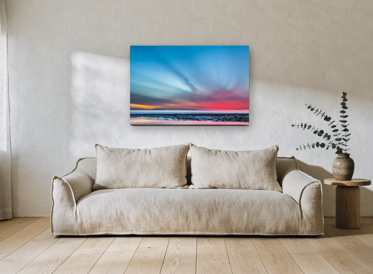 Streaked Dusk Over Low Tide coastal canvas print on the wall of a living room