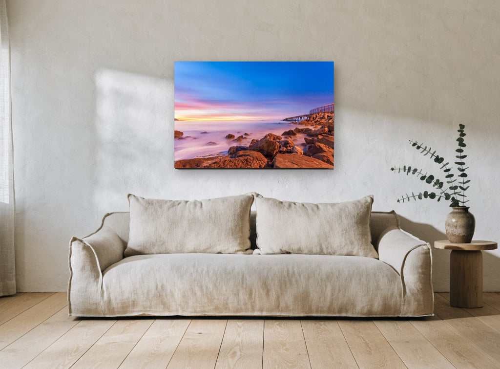 Dusk Over Rocky Shore coastal canvas print on the wall of a living room