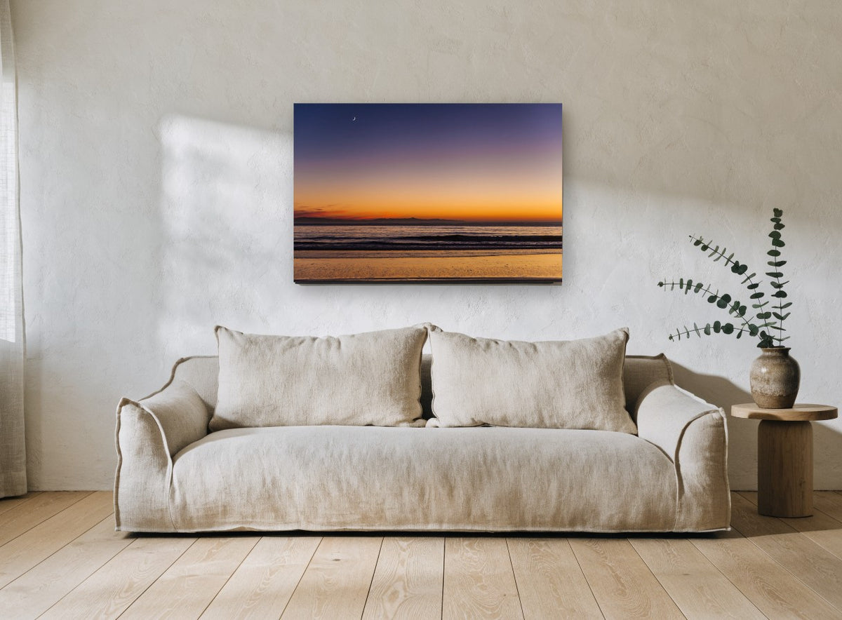 Crescent Moon Dusk coastal canvas print on the wall of a living room