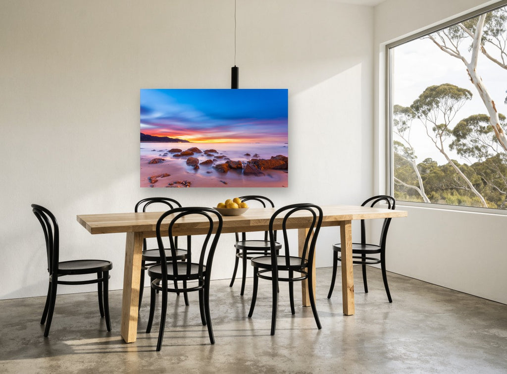 Dawn Glow Over Rocks coastal canvas print on the wall of a dining room