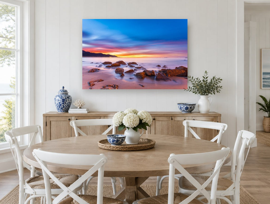 Dawn Glow Over Rocks coastal canvas print on the wall of a Hamptons dining room