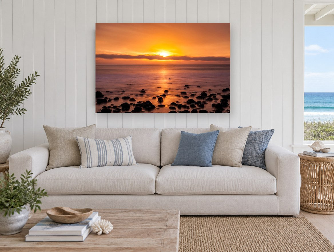 Amber Pebble Shore coastal canvas print on the wall of a beach house living room