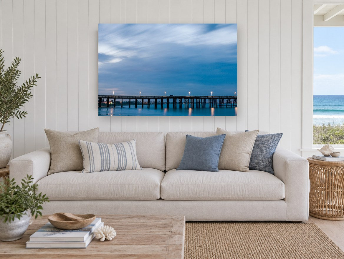 Blue Hour Pier coastal canvas print on the wall of a beach house living room