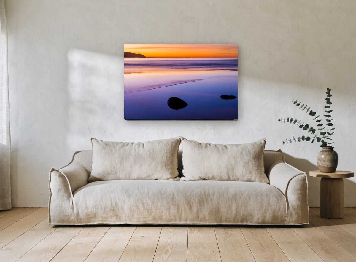 Dusk Reflections coastal canvas print on the wall of a living room