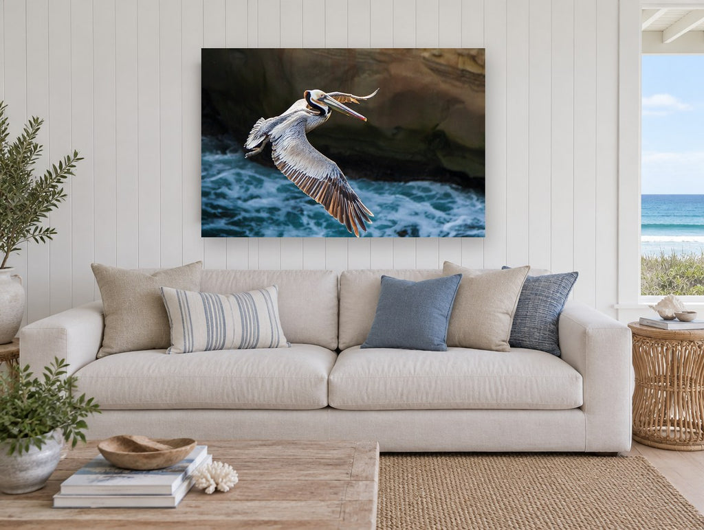 Pelican Over Surf coastal canvas print on the wall of a beach house living room