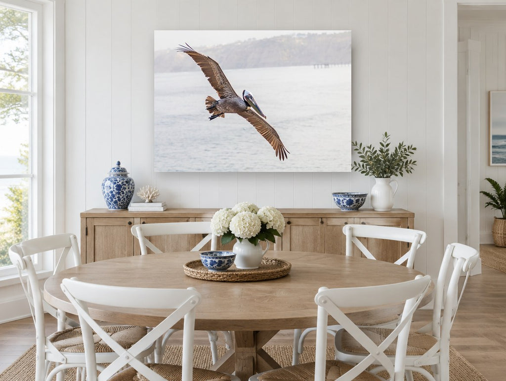 Pelican Over Still Water coastal canvas print on the wall of a Hamptons dining room