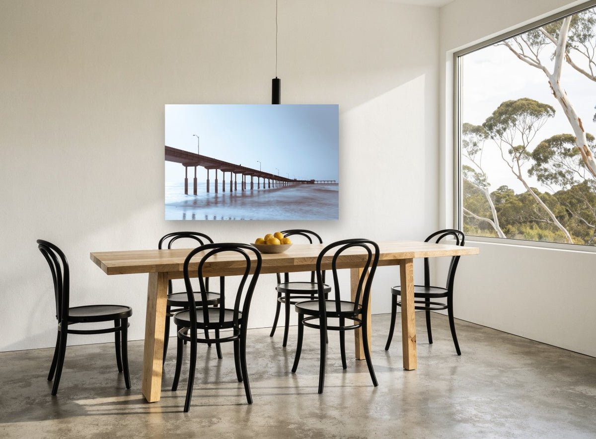 Pier in Blue Haze coastal canvas print on the wall of a dining room