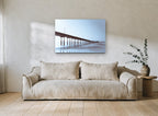 Pier in Blue Haze coastal canvas print on the wall of a living room
