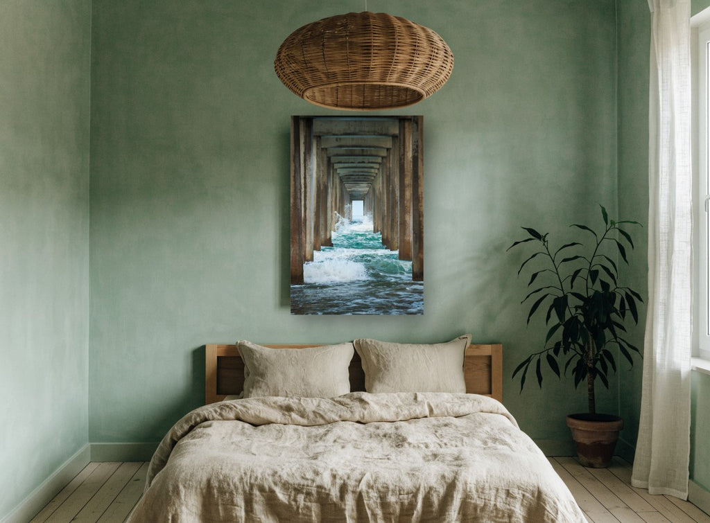 Under the Pier coastal canvas print on the wall of a bedroom