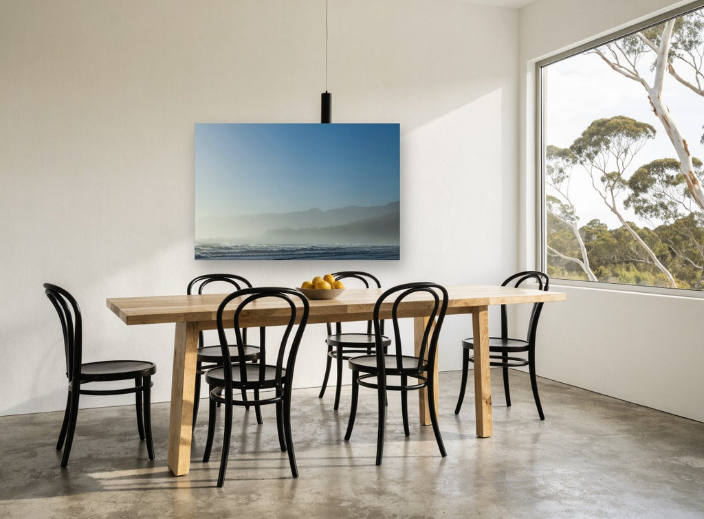 Blue Misty Shoreline coastal canvas print on the wall of a dining room
