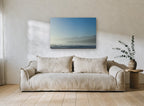 Blue Misty Shoreline coastal canvas print on the wall of a living room