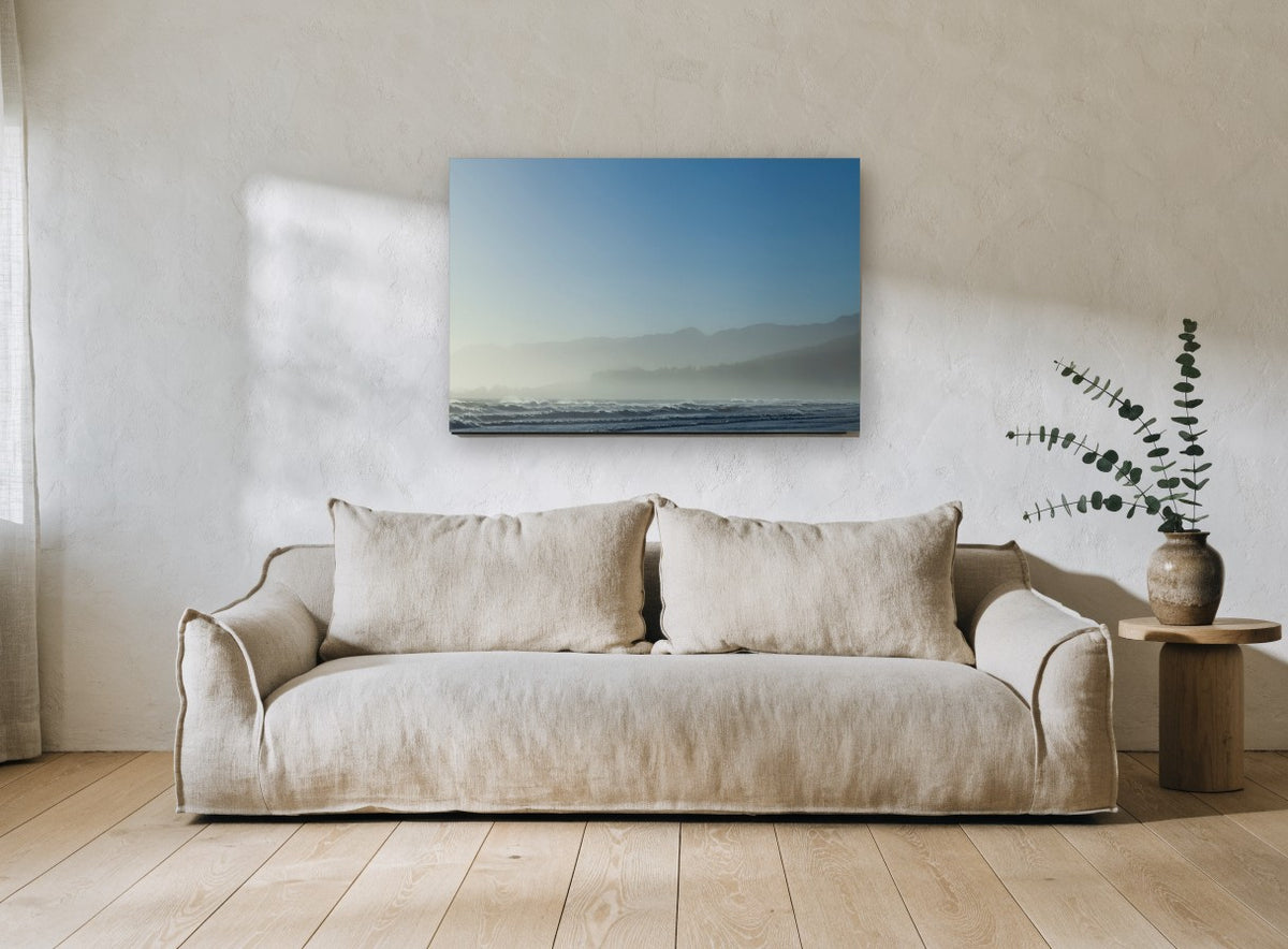 Blue Misty Shoreline coastal canvas print on the wall of a living room