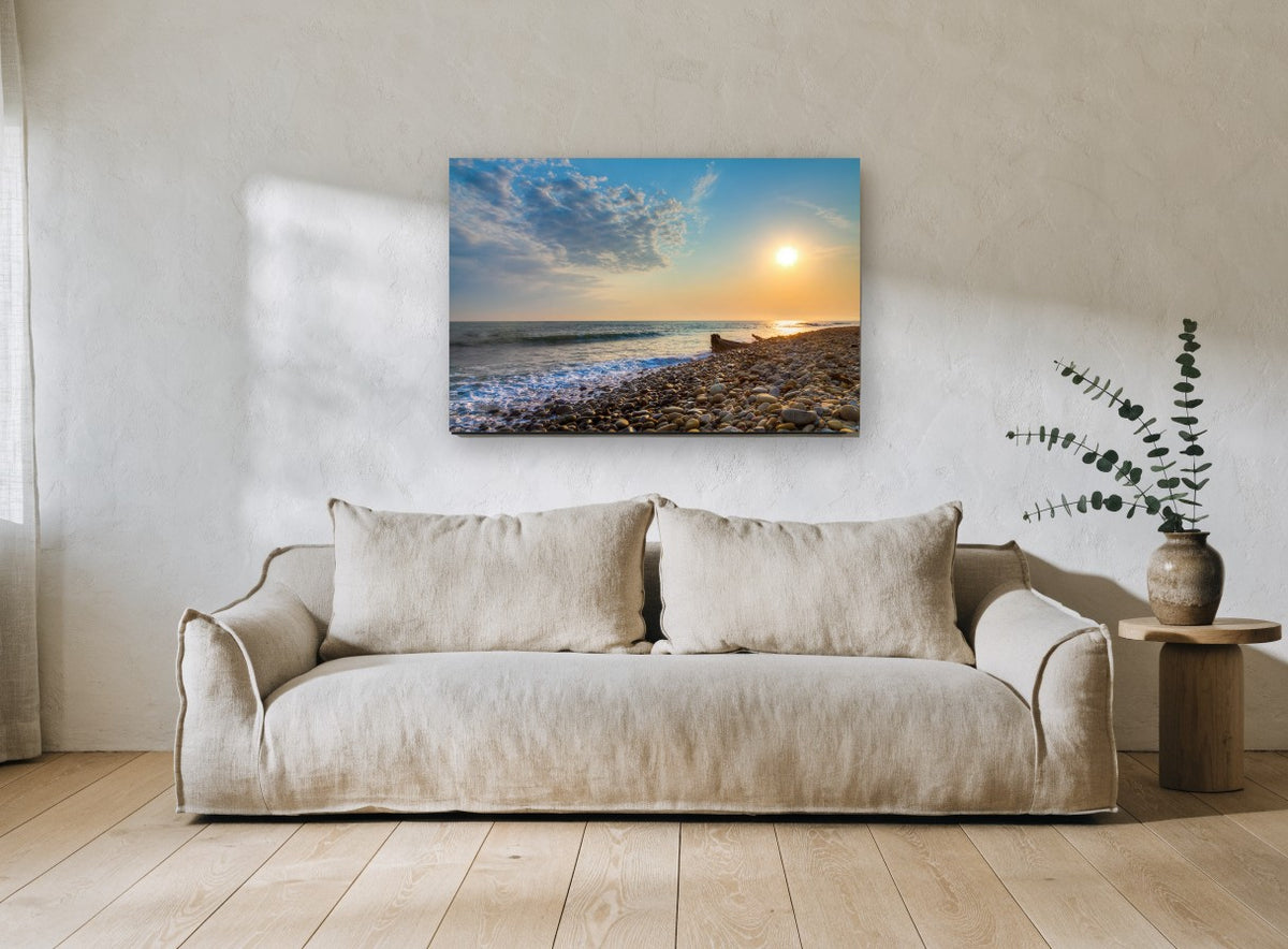 Pebble Shore Sunset coastal canvas print on the wall of a living room