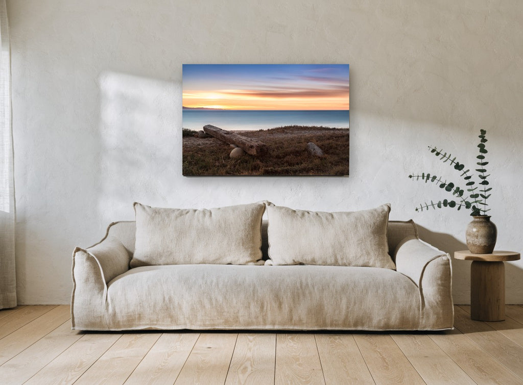 Driftwood Beam at Dusk coastal canvas print on the wall of a living room