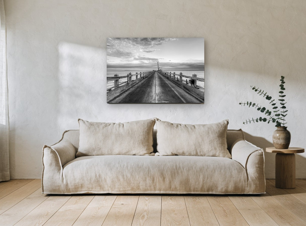 Pier Toward the Crane coastal canvas print on the wall of a living room