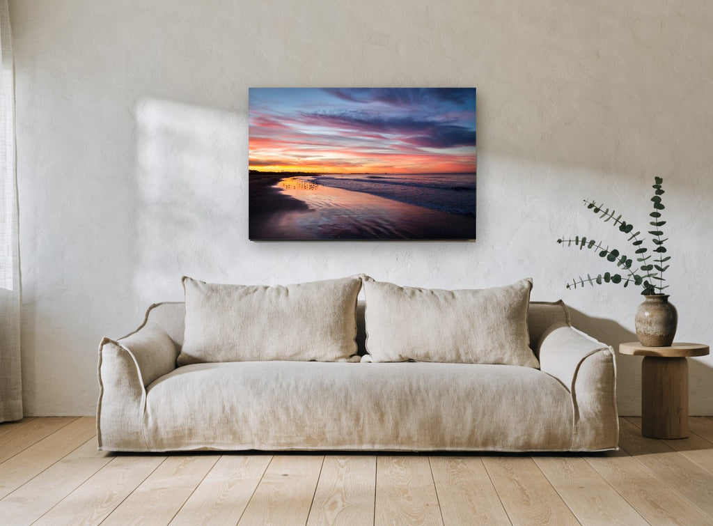 Dusk Shorebirds Glow coastal canvas print on the wall of a living room