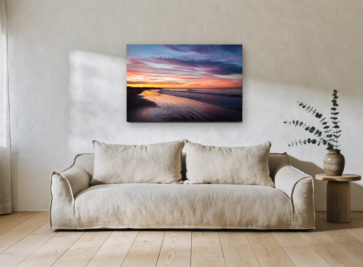 Dusk Shorebirds Glow coastal canvas print on the wall of a living room