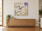 Lilac Tapestry Hummingbird floral canvas print on the wall of a living room above a sideboard