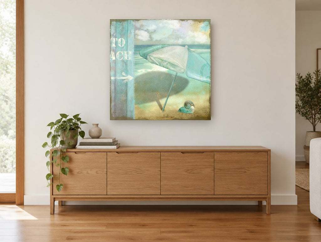 Teal Umbrella Beach Sign coastal canvas print on the wall of a living room above a sideboard