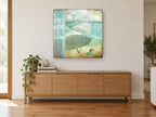 Teal Umbrella Beach Sign coastal canvas print on the wall of a living room above a sideboard