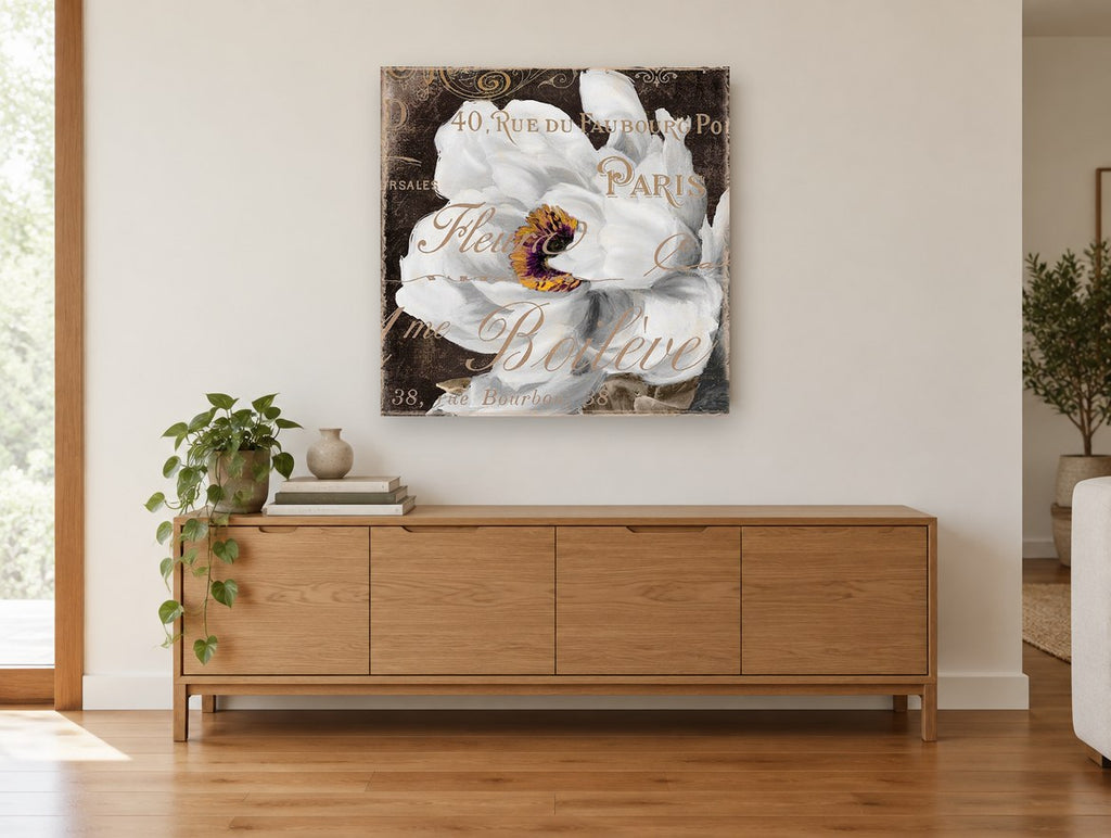 White Bloom Paris Script floral canvas print on the wall of a living room above a sideboard